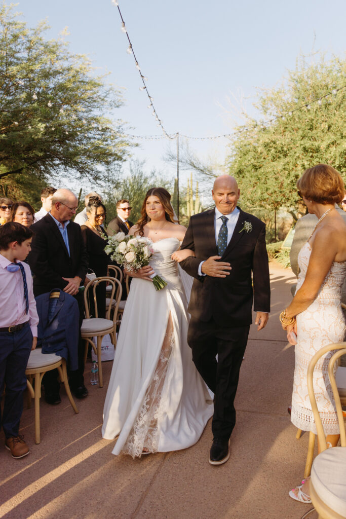 Bride walking down the aisle during a Desert Botanical Garden wedding ceremony