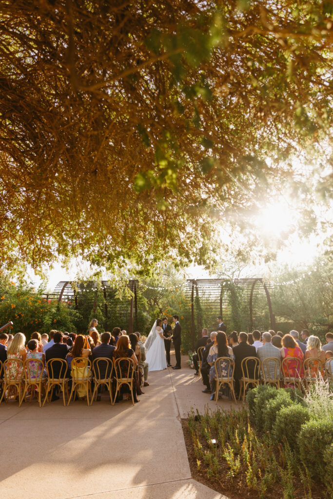 Couple exchanging vows beneath the Arizona desert sky at Desert Botanical Garden