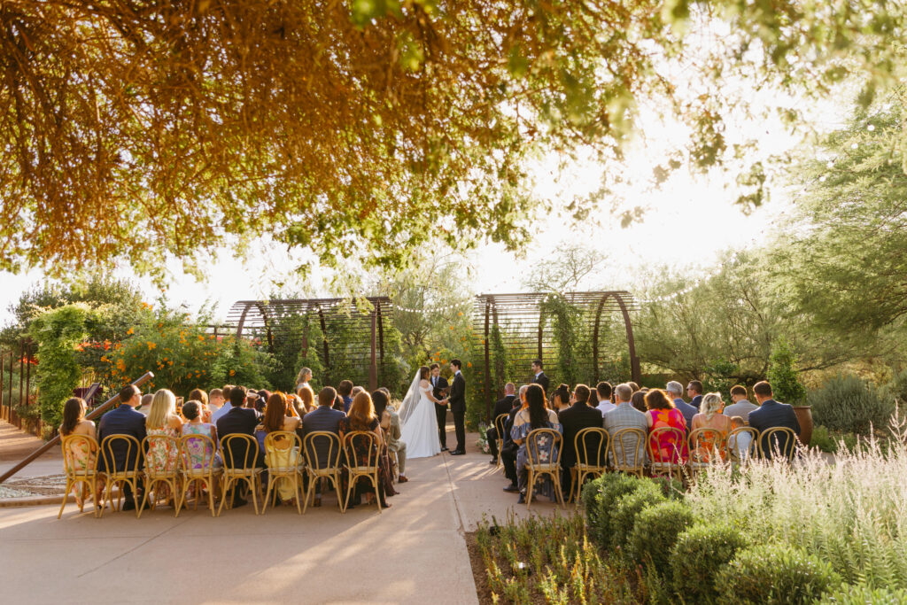 Bride and groom embracing among desert cacti during an intimate Desert Botanical Garden wedding in Phoenix, Arizona