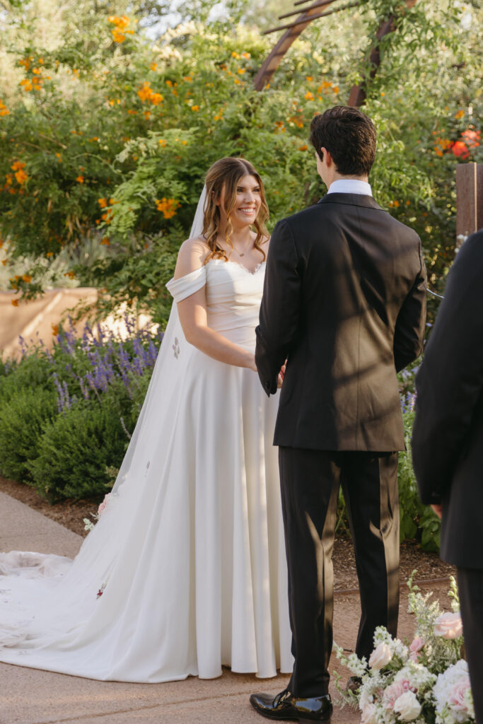 Couple exchanging vows beneath the Arizona desert sky at Desert Botanical Garden