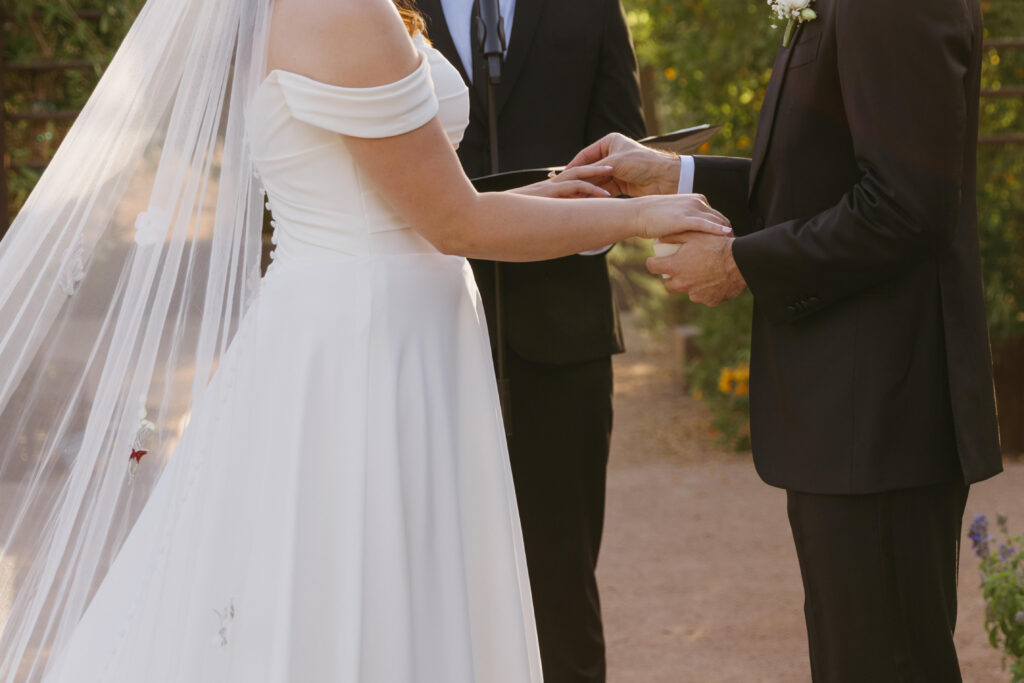 Couple exchanging vows beneath the Arizona desert sky at Desert Botanical Garden