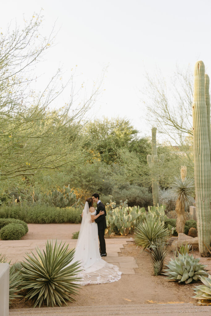 Newlyweds exploring the cactus gardens at Desert Botanical Garden after their ceremony