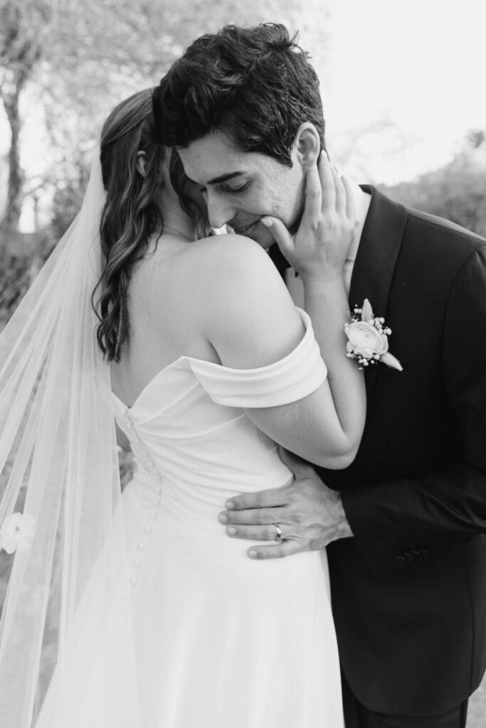 Couple embracing among desert blooms during their Desert Botanical Garden wedding