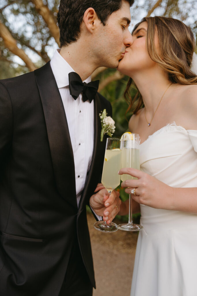 Couple embracing among desert blooms during their Desert Botanical Garden wedding