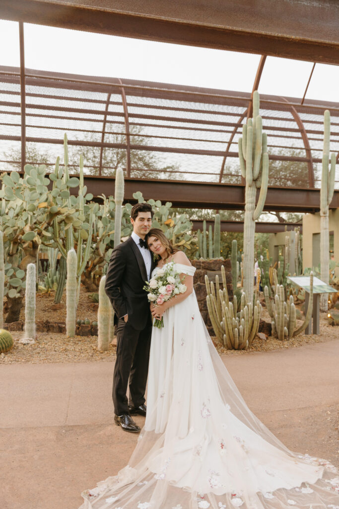 Newlyweds exploring the cactus gardens at Desert Botanical Garden after their ceremony