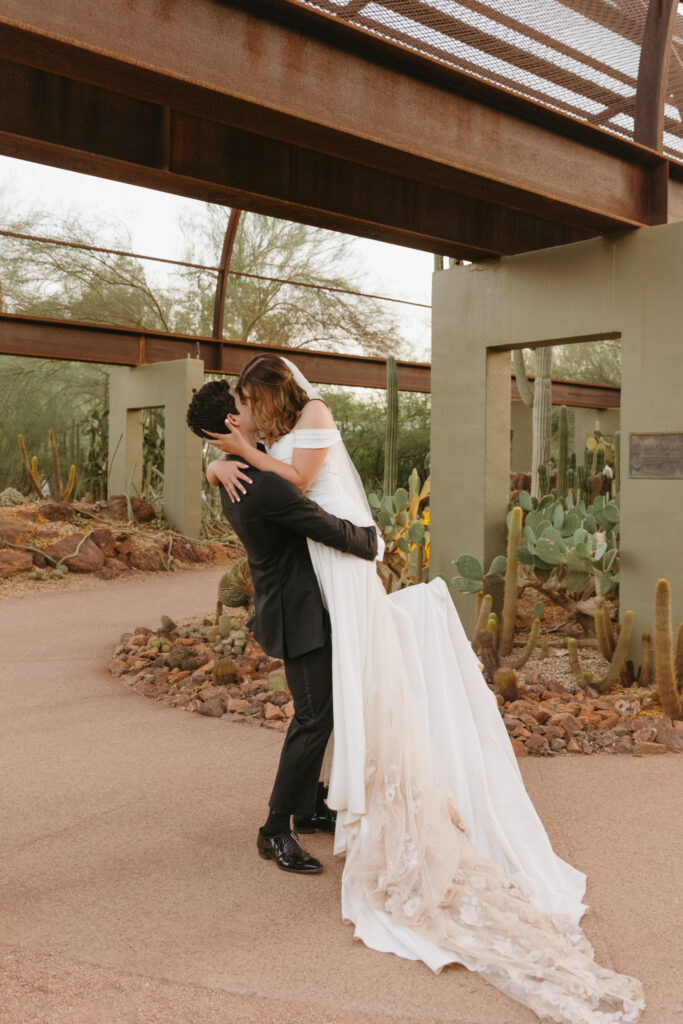 Newlyweds exploring the cactus gardens at Desert Botanical Garden after their ceremony