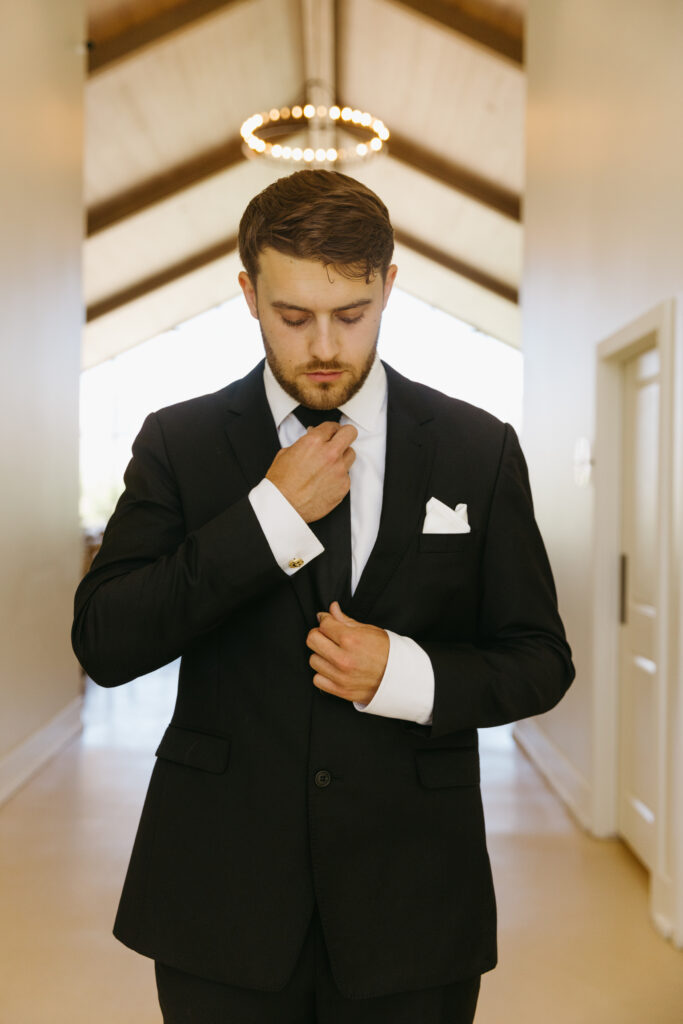 groom tying tie 