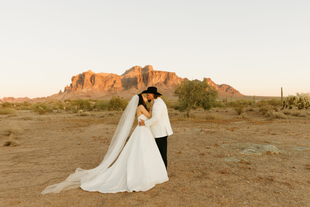 Bride and groom getting married at The Paseo with the Superstition Mountains in the background
