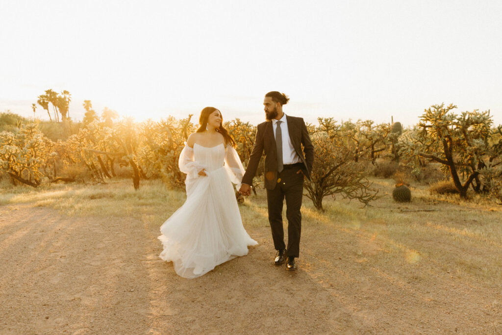 Bride and groom walking through the Sonoran Desert at JTH Tucson