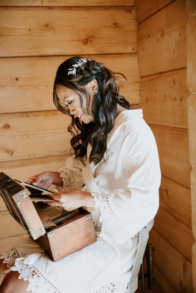 bride getting ready for Payson elopement in cabin