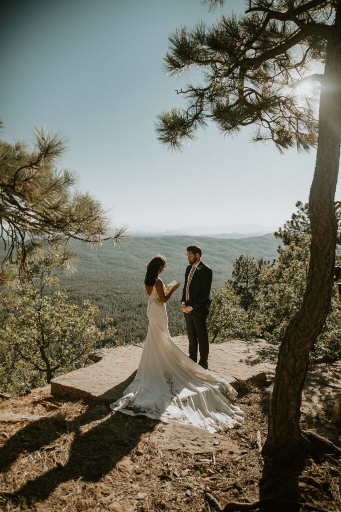 Couple sharing private vows during their Payson elopement at Mogollon Rim.