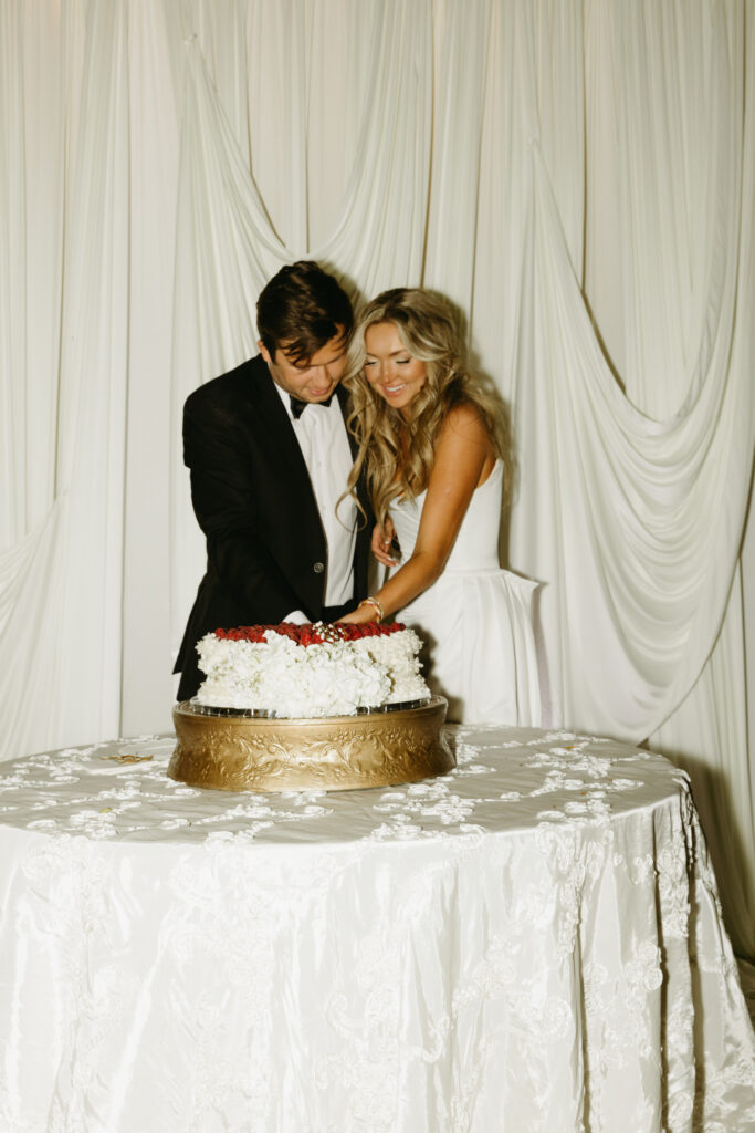 bride and groom cutting cake