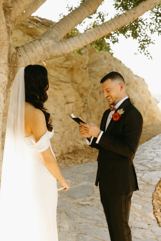 Bride and groom embracing after reading private vows at Different Pointe of View.