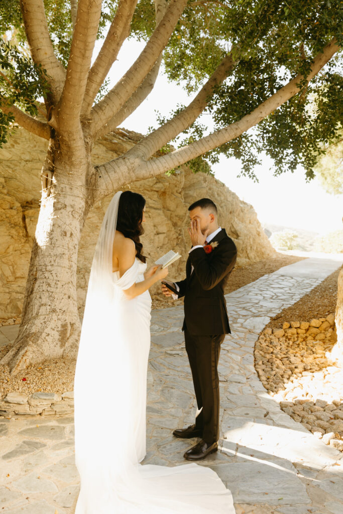 Bride and groom embracing after reading private vows at Different Pointe of View.